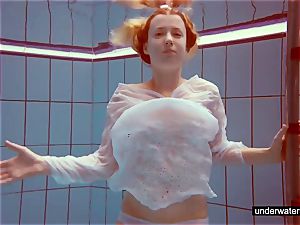 cute red-haired plays naked underwater